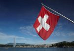 Swiss flag is pictured next to Jet d'Eau and Lake Leman from the St-Pierre Cathedrale in Geneva
